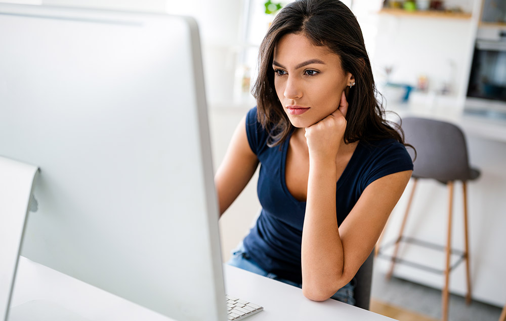 Woman at a desk working on a computer