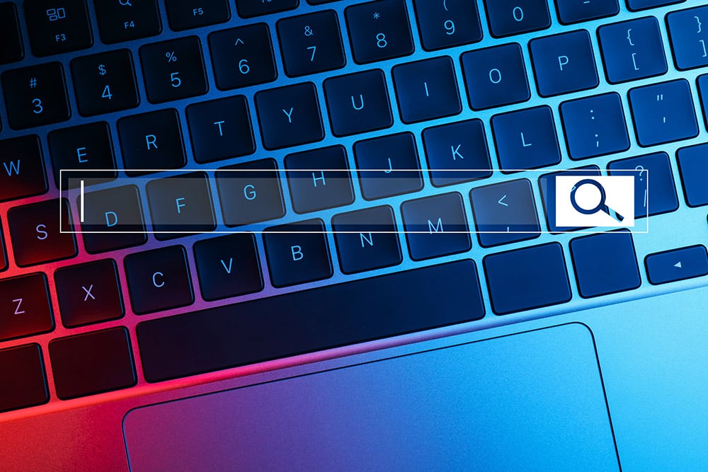 Closeup photo of a laptop with a search bar overlay
