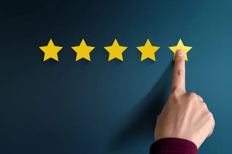 Hand pointing at a fifth star, representing a 5-star review